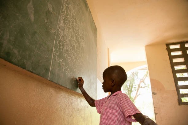 A student practicing at the chalkboard